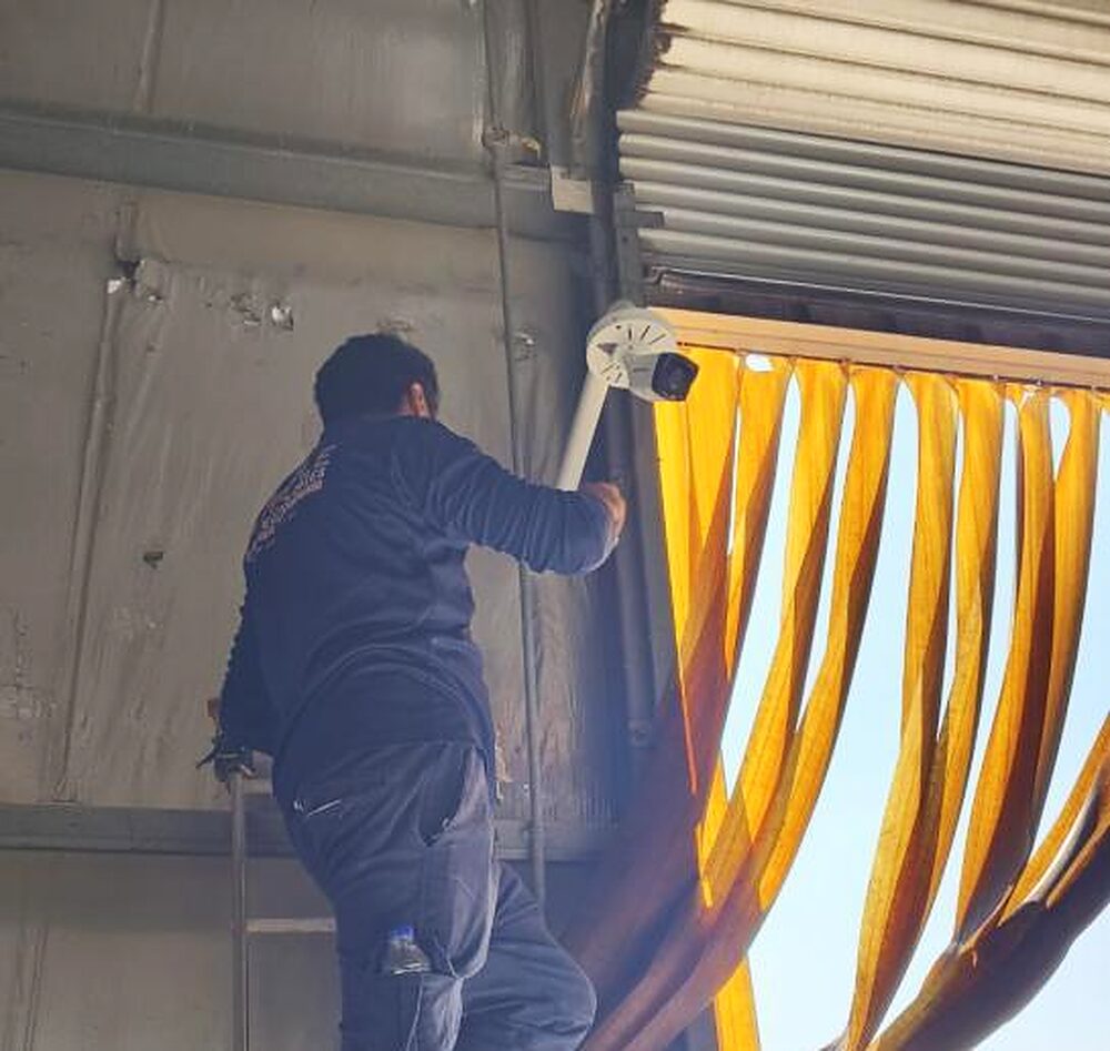 A camera being fitted above a shopfront in Dubai
